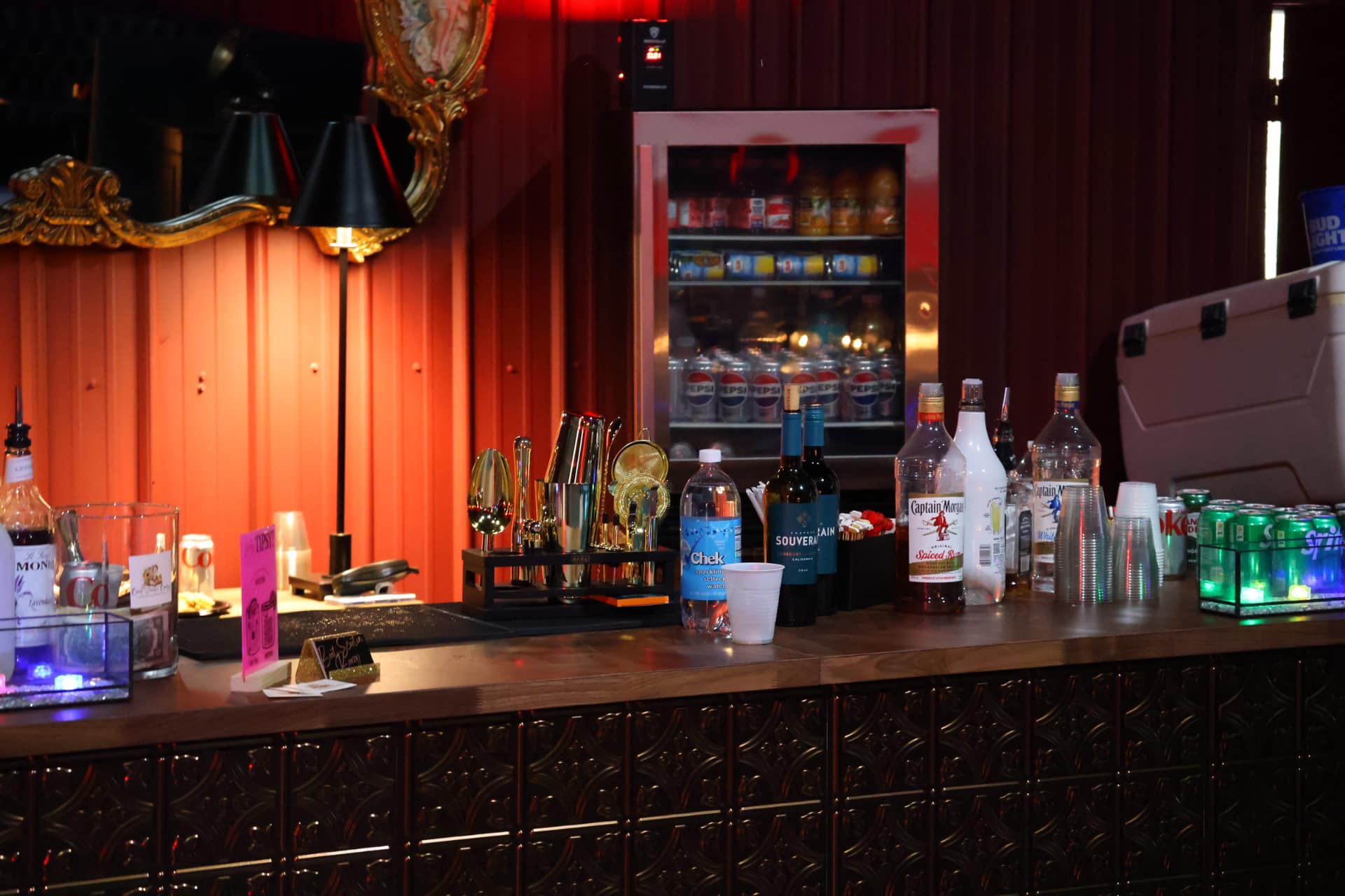 Fully stocked bar at a nighttime venue event with warm lighting