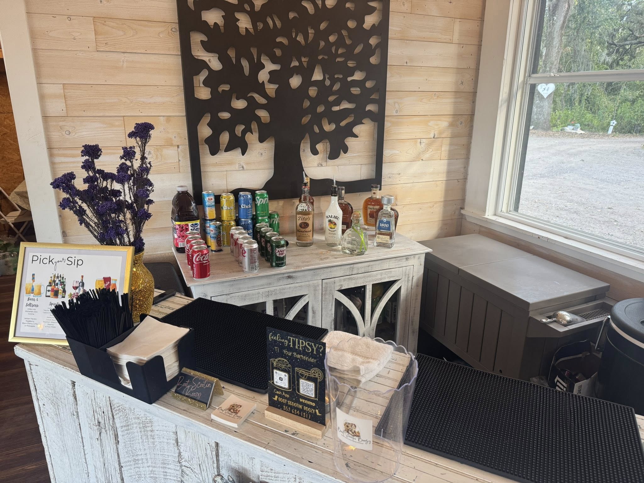 Rustic venue bar setup with country-style décor and Pick & Sip sign