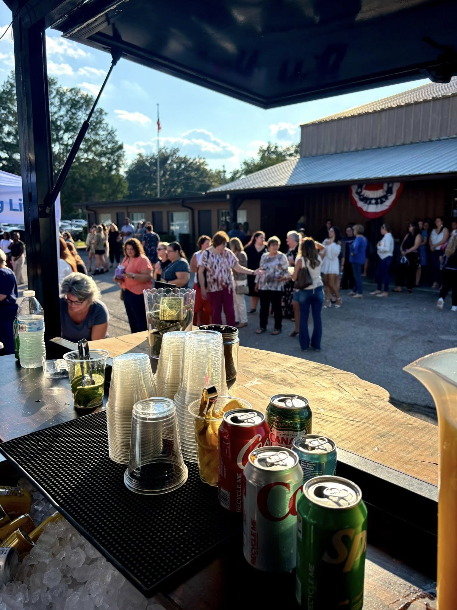View from inside the trailer bar serving a crowd at an outdoor event