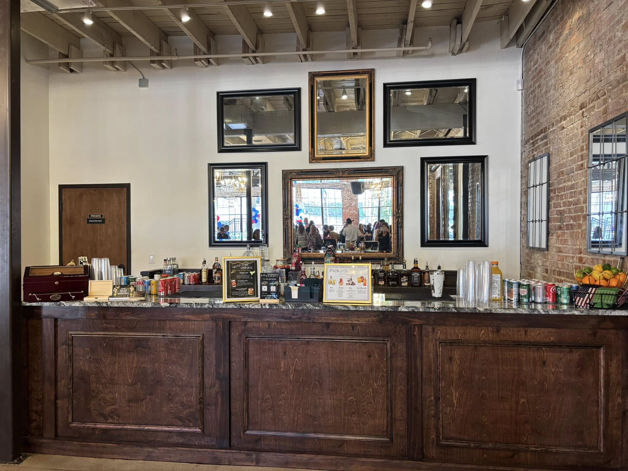 Elegant venue bar setup with dark wood and mirror displays