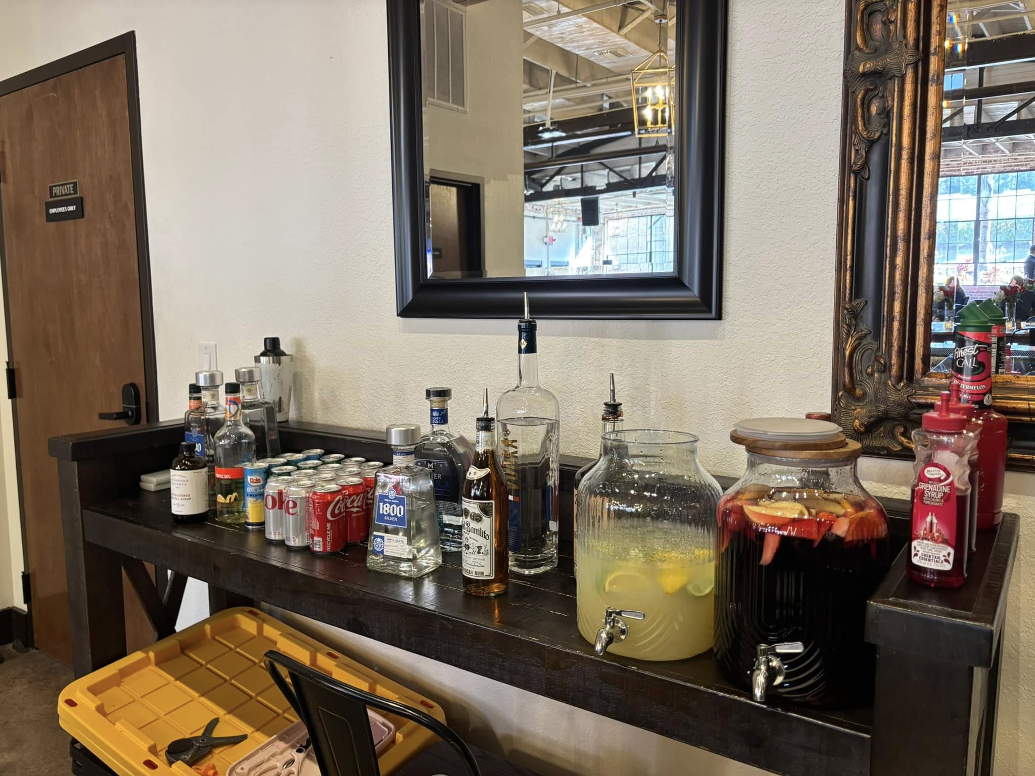 Venue bar setup with drinks, mixers, and serving dispensers